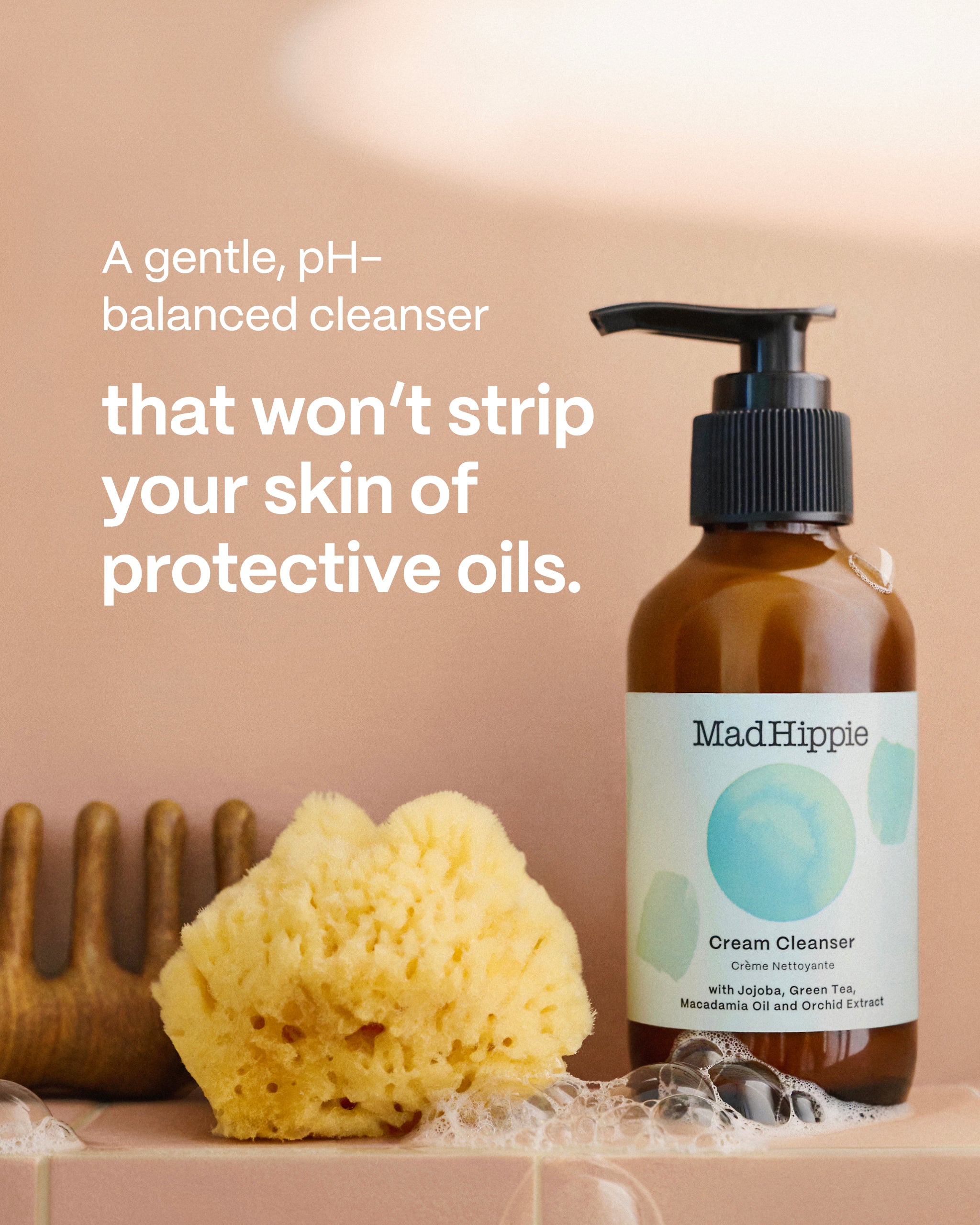 Cream Cleanser bottle with small sponge and comb on peach background + text that reads
