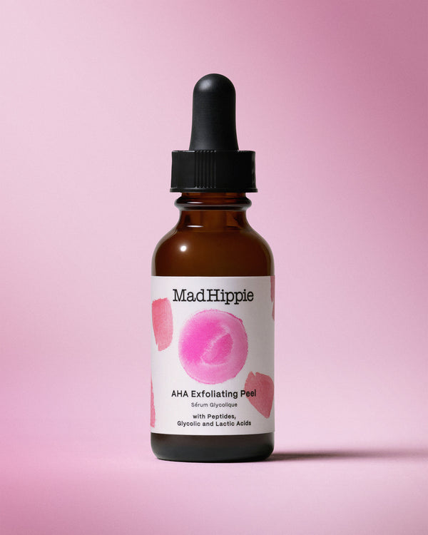 AHA Exfoliating Peel Bottle on pink background
