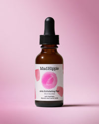 AHA Exfoliating Peel Bottle on pink background