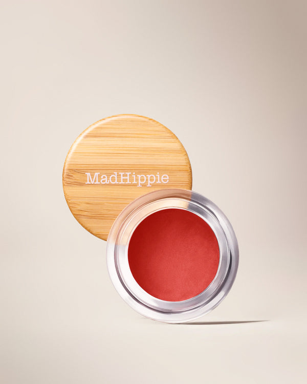 Open Poppy Cheek & Lip Tint jar with bamboo lid in background