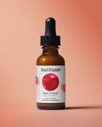 Vitamin A Serum Bottle on dark peach background